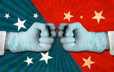 Two hands wearing latex gloves, making fists at each other, against a background of visual motifs from the Chinese and American flags