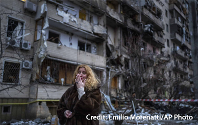 Natali Sevriukova reacts next to her house following a rocket attack on Kyiv, Ukraine, Friday, Feb. 25, 2022.
